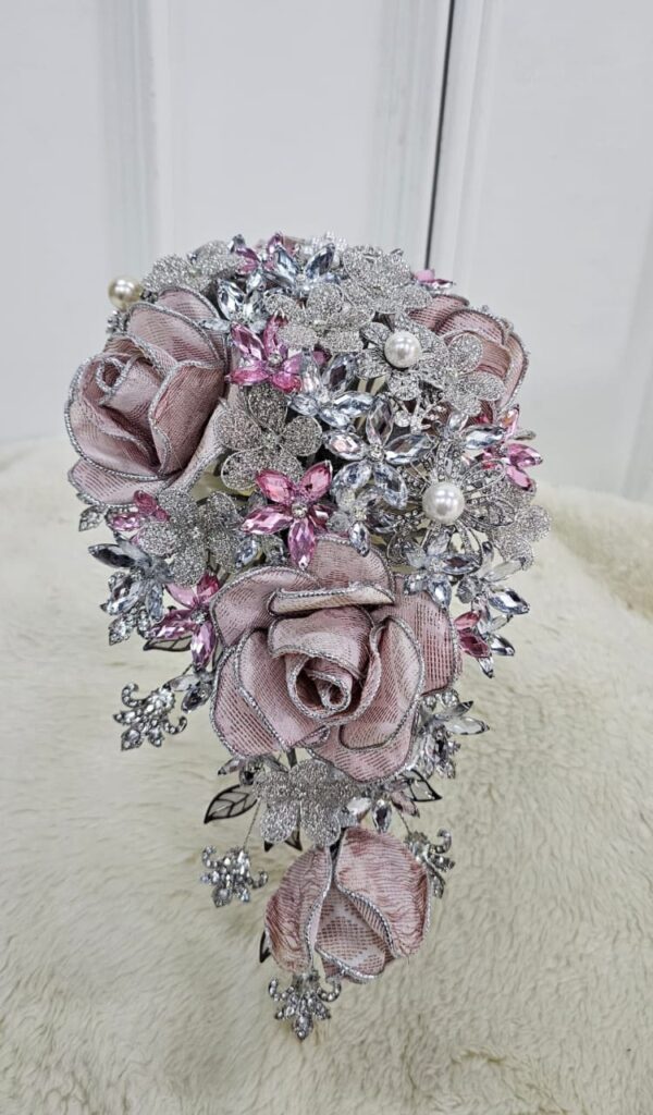Cascade hand bouquet with songket roses, crystal brooches and pearls by Shaja Ratul